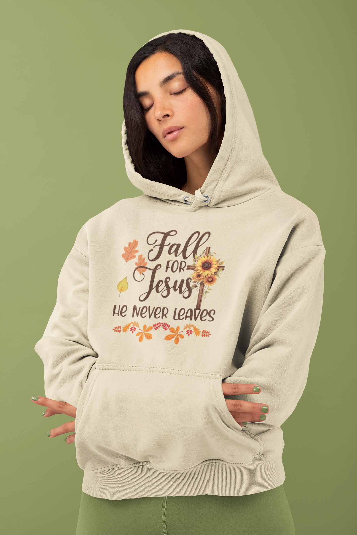 "Fall for Jesus He Never Leaves" hoodie in soft, premium fabric with elegant script design, available in various colors and sizes. Perfect for cozy fall days.