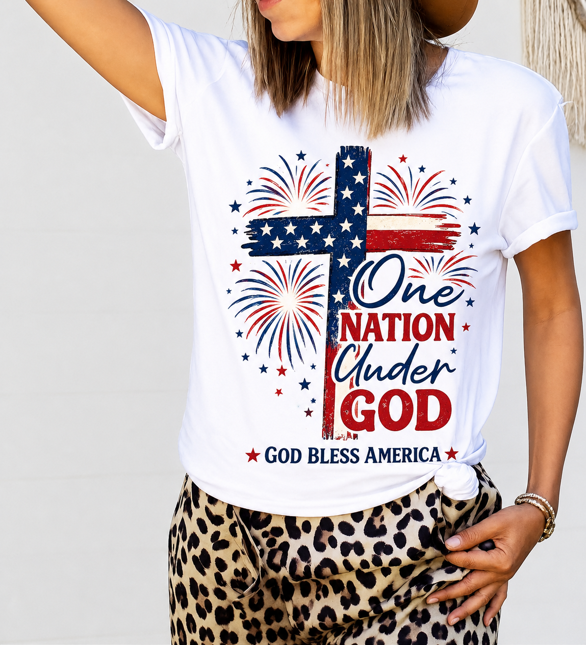 White T-shirt with a distressed flag cross, fireworks, and One Nation Under God.